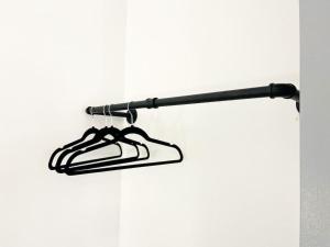 a black towel rack hanging from a wall at Birks House By RMR Accommodations - NEW - Sleeps 8 - Modern - Parking in Stoke on Trent