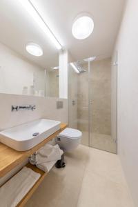 a bathroom with a toilet and a sink and a shower at VI&LA - Apart House in Piešťany