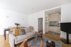 a living room with a couch and a table at Generously large 1 bedroom apartment in Farringdon in London