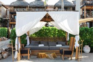 a gazebo with a couch and chairs and a table at Casa Joseph Zicatela - Adults Only in Puerto Escondido