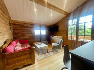 a living room with a couch and a table at Chalet Crest-Voland, 2 pièces, 4 personnes - FR-1-505-186 in Crest-Voland