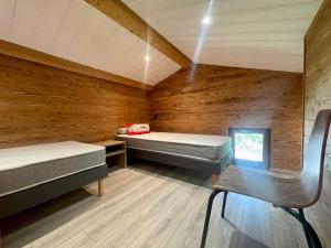 a room with two beds and a chair in it at Chalet Crest-Voland, 2 pièces, 4 personnes - FR-1-505-186 in Crest-Voland