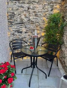 a black table with a candle on a patio at Seagrass Cottage - Aberdovey in Aberdyfi