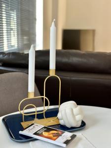 two candles on a tray on a table at Overlooking city centre apt in Waterford