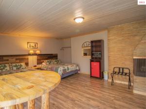 a room with two beds and a table in it at The Idaho Lodge & RV Park in Bonners Ferry