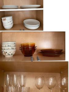 two pictures of plates and bowls and glasses on a shelf at Brand new 1Queenbed family suite near UBC in Vancouver