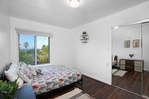 a bedroom with a bed and a large window at Breathtaking Bayview home in San Diego