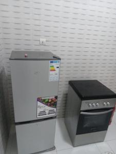 a small refrigerator next to a box of fruit at Salam in Saint-Louis