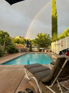 a chair sitting next to a pool with a rainbow at The Cottage at 241 North in St. George