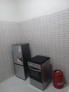 a kitchen with a refrigerator and a stove at Salam in Saint-Louis