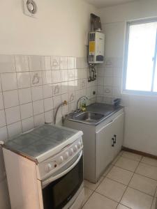 a small kitchen with a stove and a sink at CASA AMOBLADA EN TALCA PARA 6 PERSONAS in Talca