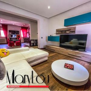 a living room with a couch and a tv at Residenza MaryLou in Porto SantʼElpidio
