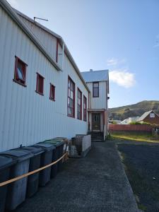 a building with barrels in front of it at Central Apartments in Vestmannaeyjar