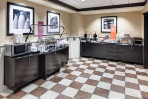 a kitchen with a checkered floor at Hampton Inn & Suites Gainesville Downtown in Gainesville