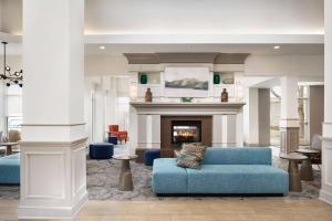 a living room with a couch and a fireplace at Hilton Garden Inn Fort Collins in Fort Collins