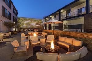 a patio with couches and tables and chairs at Hilton Garden Inn Davis Downtown in Davis