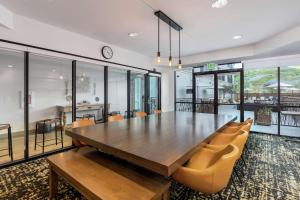 a dining room with a large wooden table and chairs at Hilton Garden Inn Davis Downtown in Davis