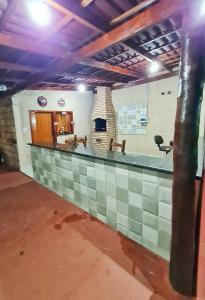 a bar in a building with a fireplace at POUSADA POR DO SOL in Olímpia +32 photos