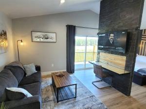 a living room with a couch and a piano at Luxurious Mountain Retreat! in Show Low