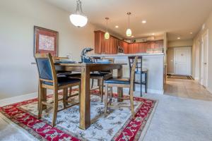 a kitchen and dining room with a wooden table and chairs at River's Edge at Bridgeport in Seaside