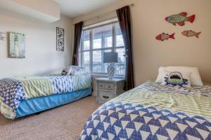 a bedroom with two beds and a window at River's Edge at Bridgeport in Seaside