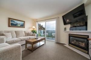 a living room with a couch and a fireplace at Waters Edge 402 in Lincoln City