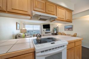 a kitchen with a white stove top oven in a room at Waters Edge 402 in Lincoln City
