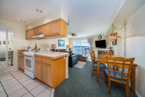 a kitchen and dining room with a table and chairs at Waters Edge 404 in Lincoln City