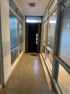 a hallway of a building with windows and a door at Liban 1 in San Juan