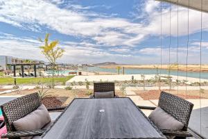 a wooden table and chairs with a view of the desert at Eagle Village at Islas del Mar C7 in Puerto Peñasco