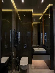 a bathroom with a toilet and a sink and a shower at Lighthouse, Sea Breeze in Baku