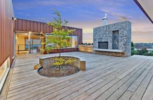 a house with a fireplace on a wooden deck at Serendipity Vista in Warrnambool