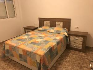 a bedroom with a bed with a quilt on it at casa luis in Costa de Antigua