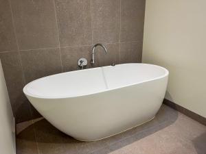 a white bath tub sitting in a bathroom at Serendipity Vista in Warrnambool
