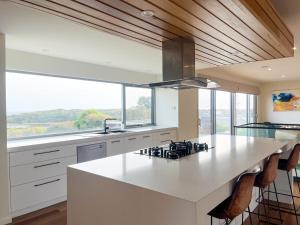 a kitchen with a large white counter and a large window at Serendipity Vista in Warrnambool