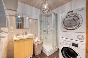a bathroom with a washing machine and a shower at Le Chalet des Eaux - Thermes - Ski in Revel