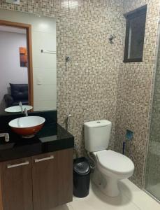 a bathroom with a toilet and a sink and a mirror at Flat com ótima localização - 505 in Campina Grande