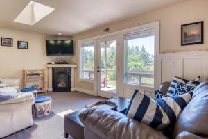 a living room with a couch and a fireplace at Ocean Pines in Tillamook