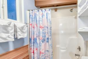 a shower curtain in a bathroom next to a window at Silver Star in Rockaway Beach +31 photos