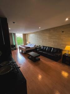 a living room with a couch and a bed at Giakor Suites - Gran Jardín in León