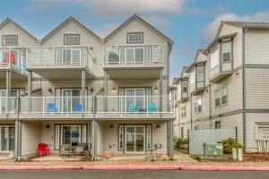 an apartment building with balconies and tables and chairs at The Cozy Corner in Rockaway Beach
