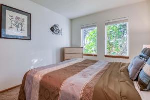 a bedroom with a large bed and two windows at The Lookout in Newport