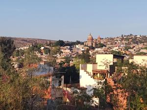 a view of a city from the hills at Laica House in San Miguel de Allende