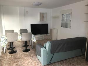 a living room with a couch and chairs and a television at casa luis in Costa de Antigua