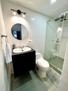 a bathroom with a sink and a toilet and a mirror at Vive como un local en Popayan in Popayan
