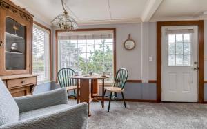 a living room with a table and chairs at Little Cottage at the Coast in Seaside