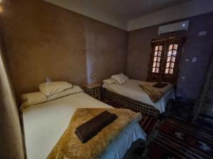 a room with two beds and a window at SEMIRAmis Siwa in Siwa