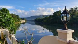 a light on a wall next to a river at Casa Marina Bed and Breakfast in Pagsanjan