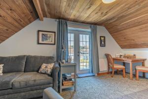 a living room with a couch and a table at UPSTAIRS Alki Beach APARTMENT - Seattle -Historic-1858 in Seattle