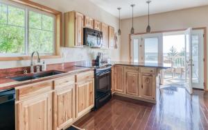 a kitchen with wooden cabinets and a large window at Haven Hill in Cloverdale